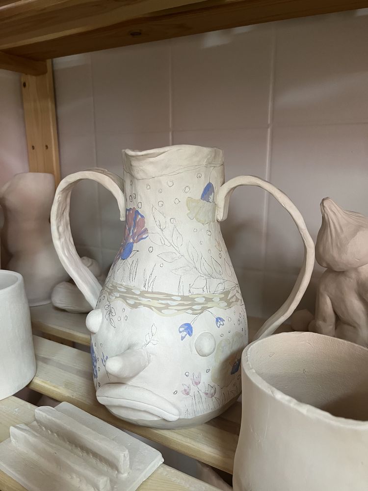 Painted jug drying on shelf