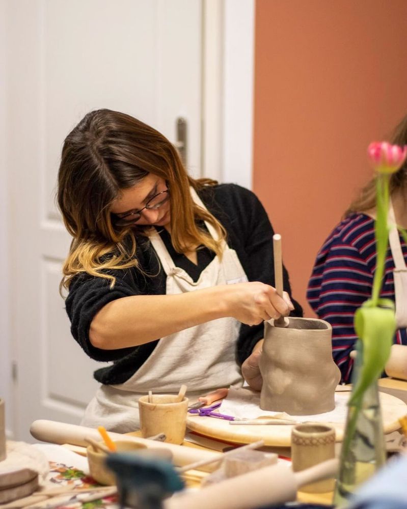 Yev shaping clay in the studio